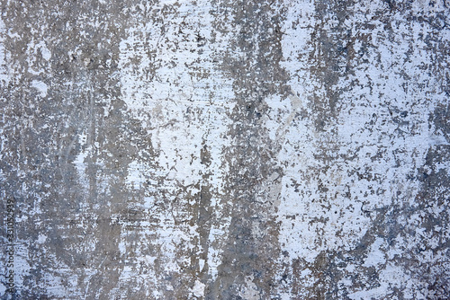 Weathered and peeled off concrete cracked wall. Old wall texture. Rough cracked wall background painted in white. © dneezz