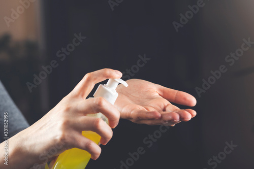 woman squeeze gel tube using a hand wash to prevent germs protect virus