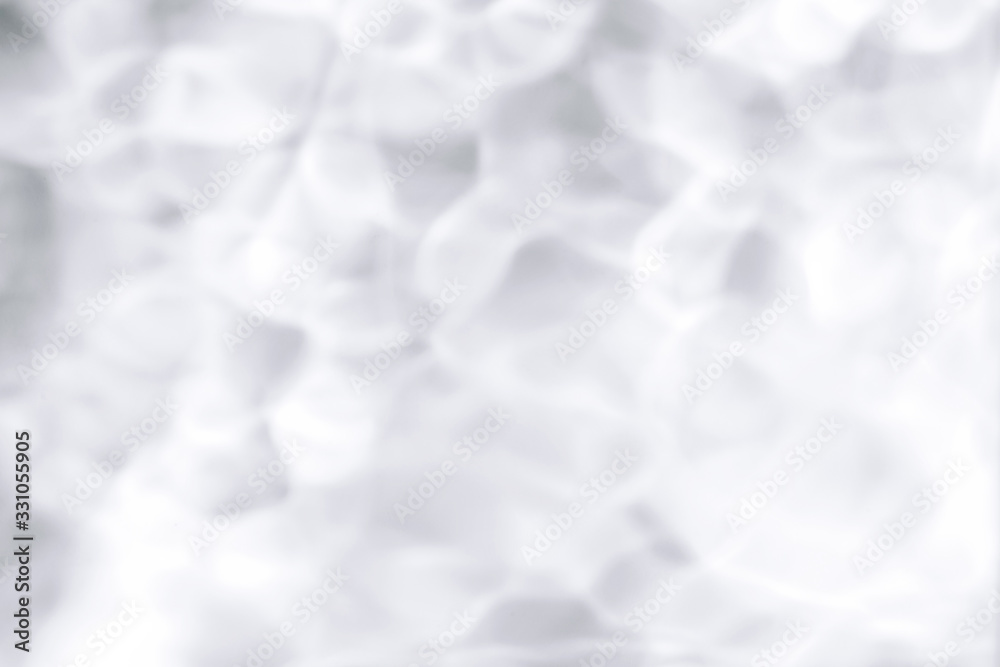 Shadows made with water. Blurred background made with water and light in monochrome. Pureness concept.