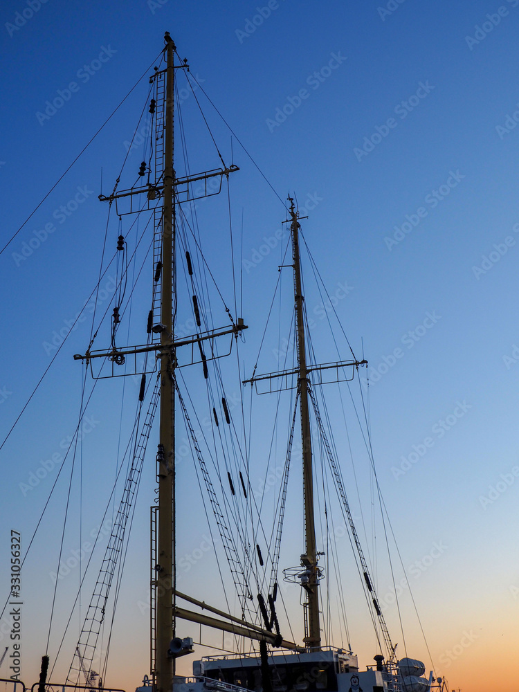 Sunset cityscape with old sailing ship