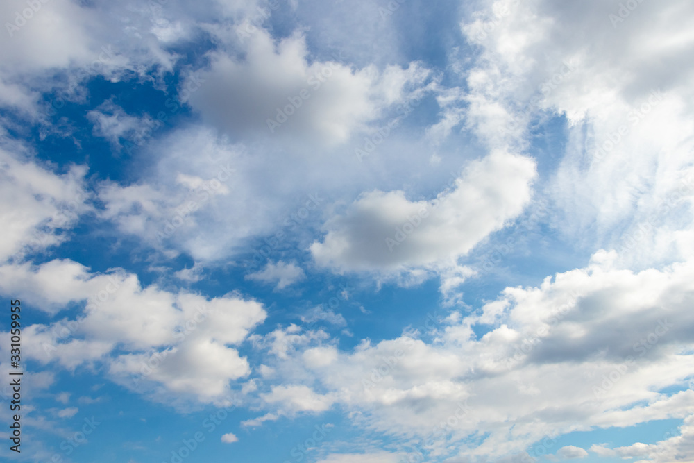 White fluffy clouds in the blue sky in sunny weather_ White fluffy clouds in the blue sky in sunny weather_