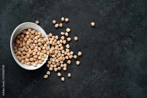  chickpeas in a bowl on a stone background photo