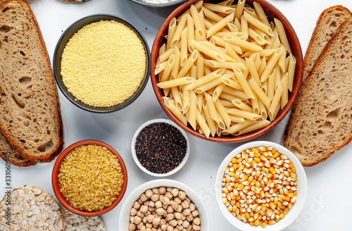 Selection of gluten free food. Chickpeas, bread, couscous, bulgur, pasta, bread, flour, quinoa on a white background, isolated