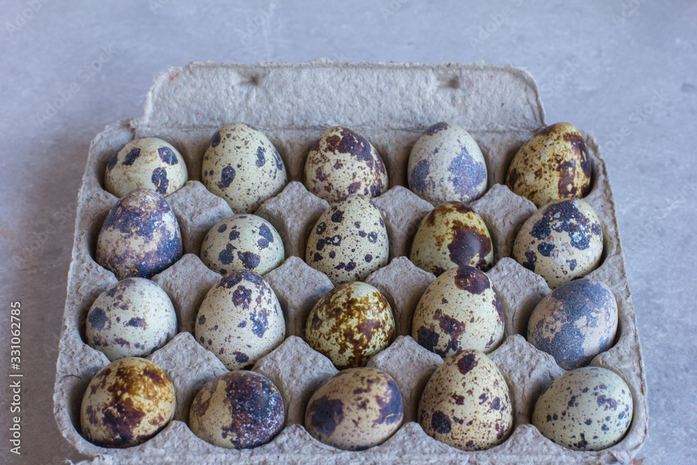 Fototapeta premium The quail eggs are in cardboard packaging on the table