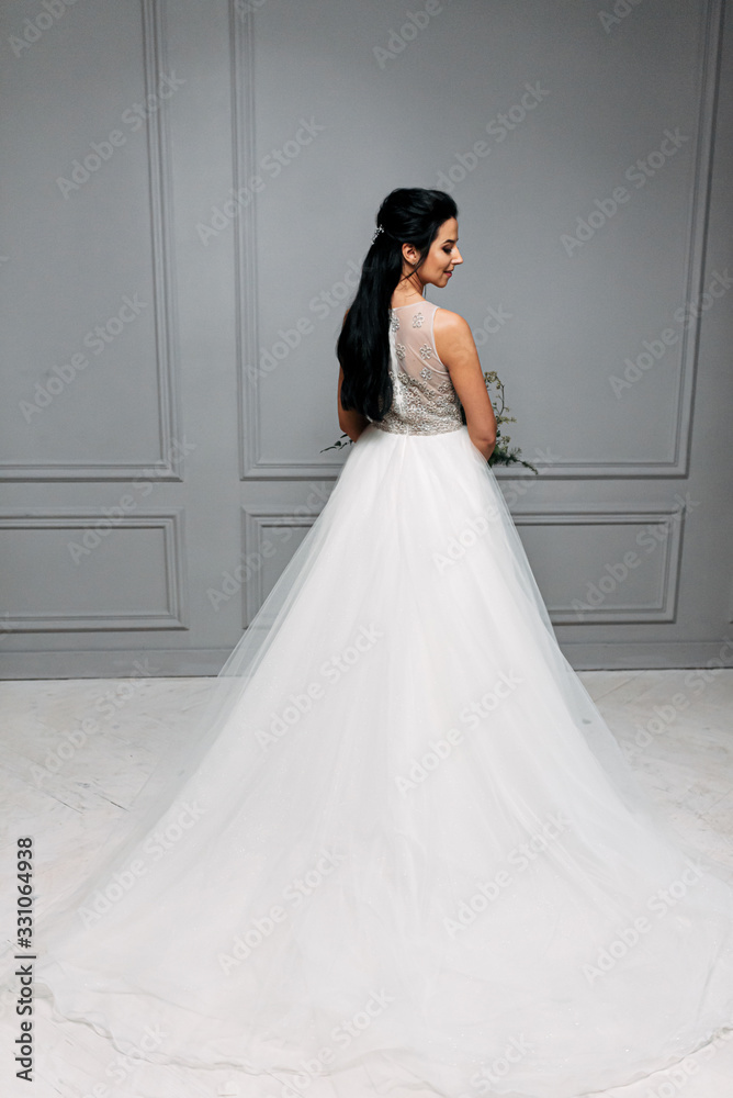 Studio photo of the bride in a chic long dress