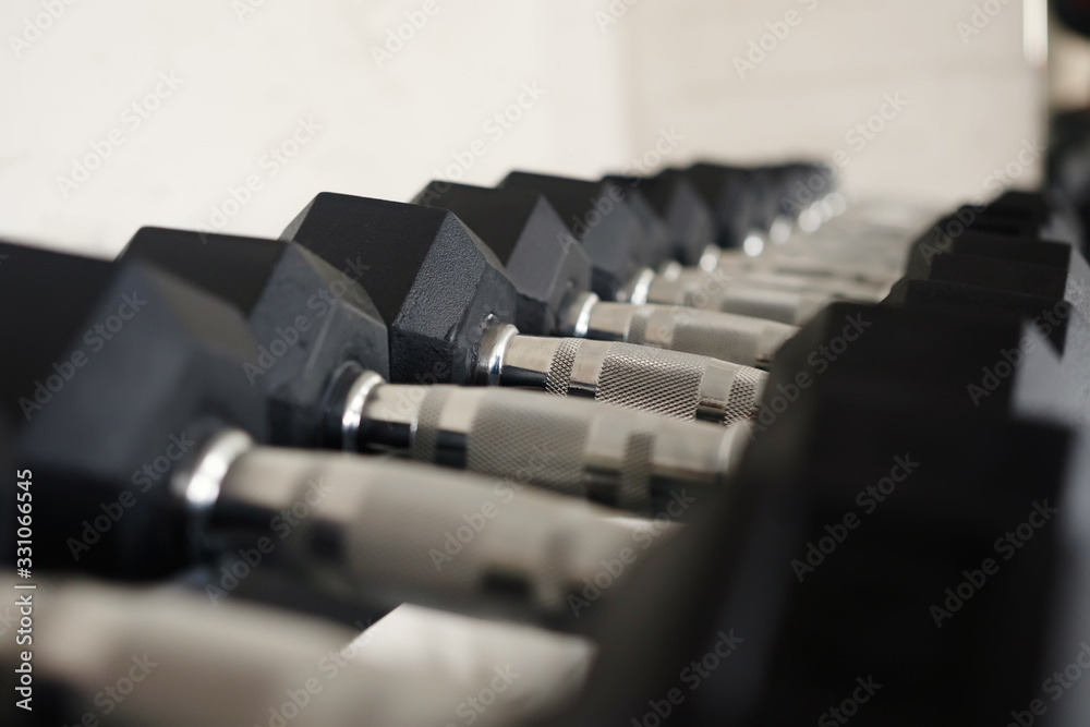 Naklejka premium A row of dumbbells.