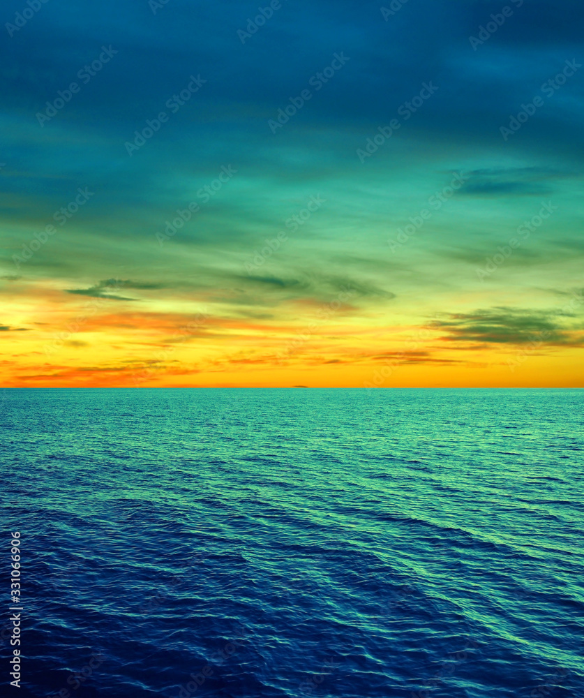 Obraz premium Cyan yellow sea water sky clouds background
