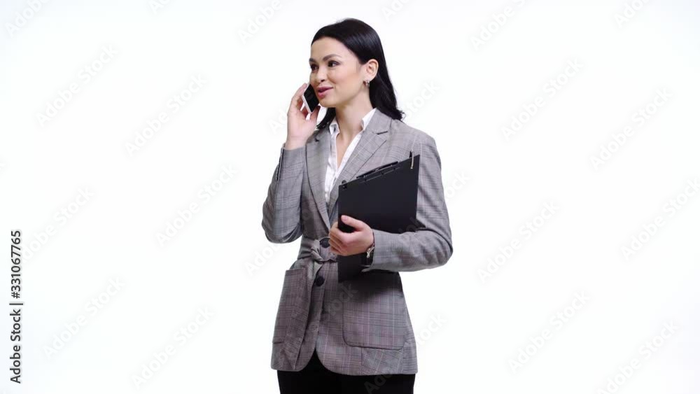 Businesswoman with clipboard talking on smartphone isolated on white
