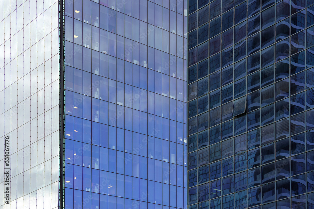 Abstract modern building background for design. Glass architecture of a modern building. The texture of the windows of the building.