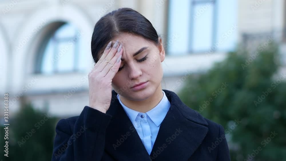 Tired business woman puts down glasses and rubbing forehead Tired business woman puts down glasses and rubbing forehead