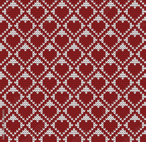 Seamless knitted decorative pattern with red hearts