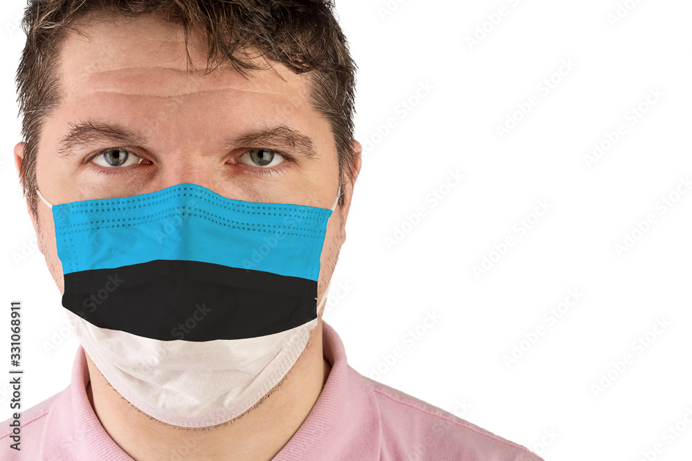 Portrait of adult caucasian man who wears protective mask on his face against influenza and protect health from bacteria. Flag of Estonia. Portrait of adult caucasian man who wears protective mask on his face against influenza and protect health from bacteria. Flag of Estonia.