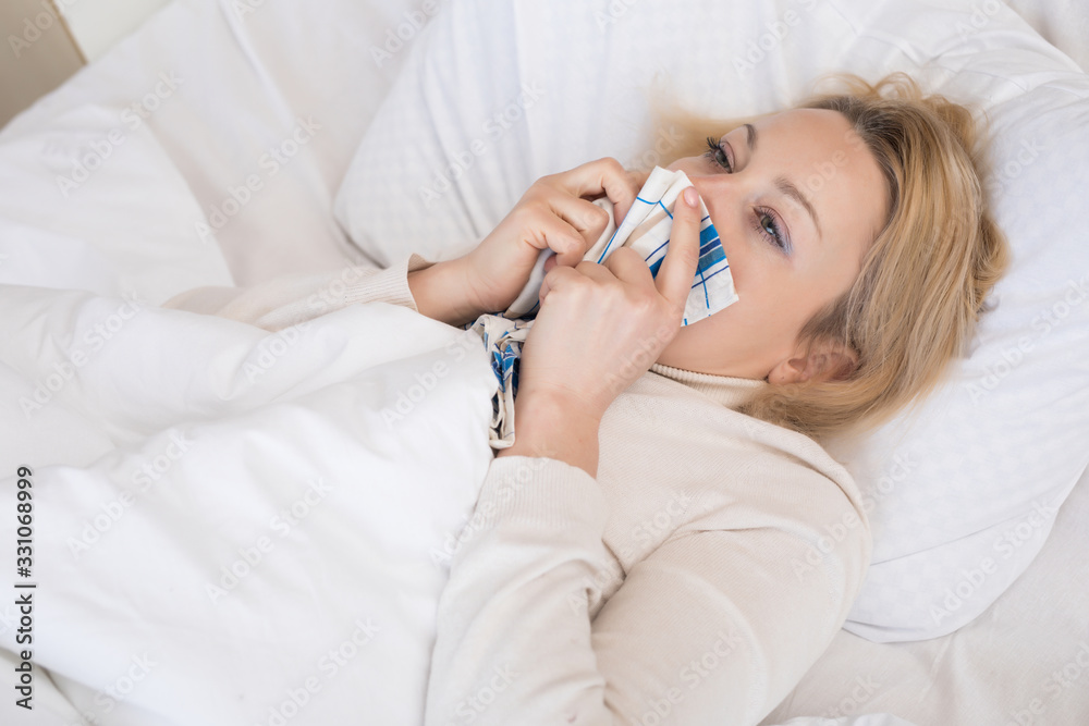 Sick woman lying in bed with high fever. Virus infection. Sick woman lying in bed with high fever. Virus infection.