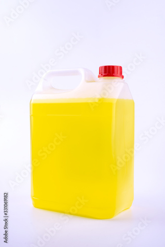 Plastic canister with pen and red cap, yellow liquid, mock up object, isolated on white background. photo