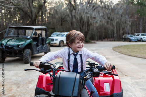 smiling 6 year old boy on ATV, Georgia