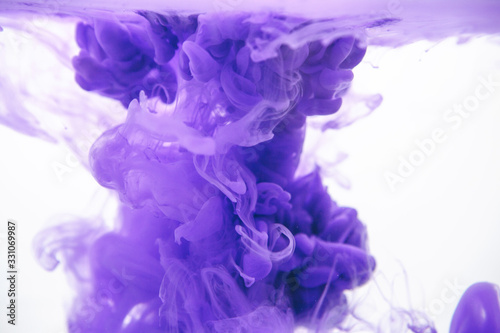 Purple color ink in water on a white background.