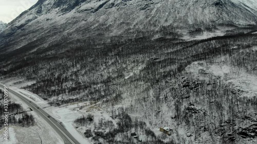 aerial fly over tilted shot with view of islands and coastal road in northen Norway Lofoten islands
