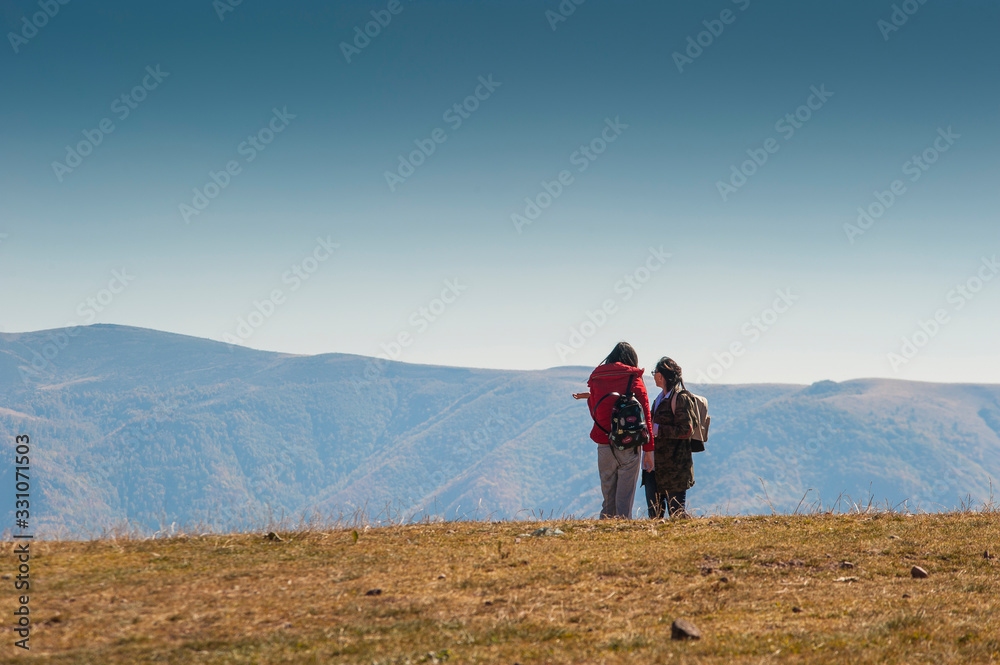 Two mountaineers walk through the mountain at dusk