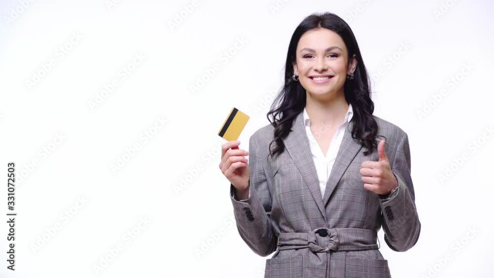 Businesswoman smiling, showing credit card and like sign isolated on white Businesswoman smiling, showing credit card and like sign isolated on white
