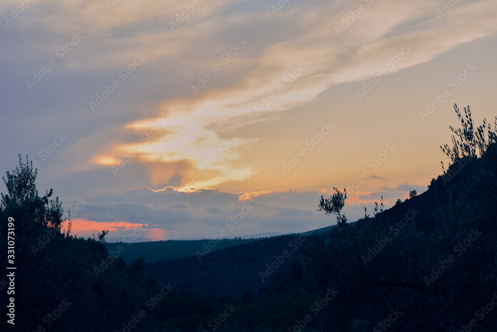 Sunset in mountainous landscape with forest