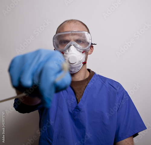 doctor in medical mask taking swob photo