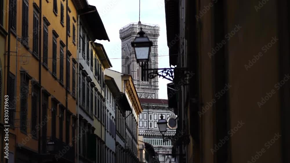 Piazza del Duomo seen thru old street. Historic centre of Florence, Italy, major tourist attraction of Tuscany. Summer tourism & family travel destination in Europe.