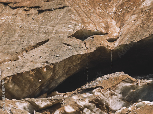 Water flows on the dirty melting glacier in Caucasus mountains, Georgria, Shkhara glacier