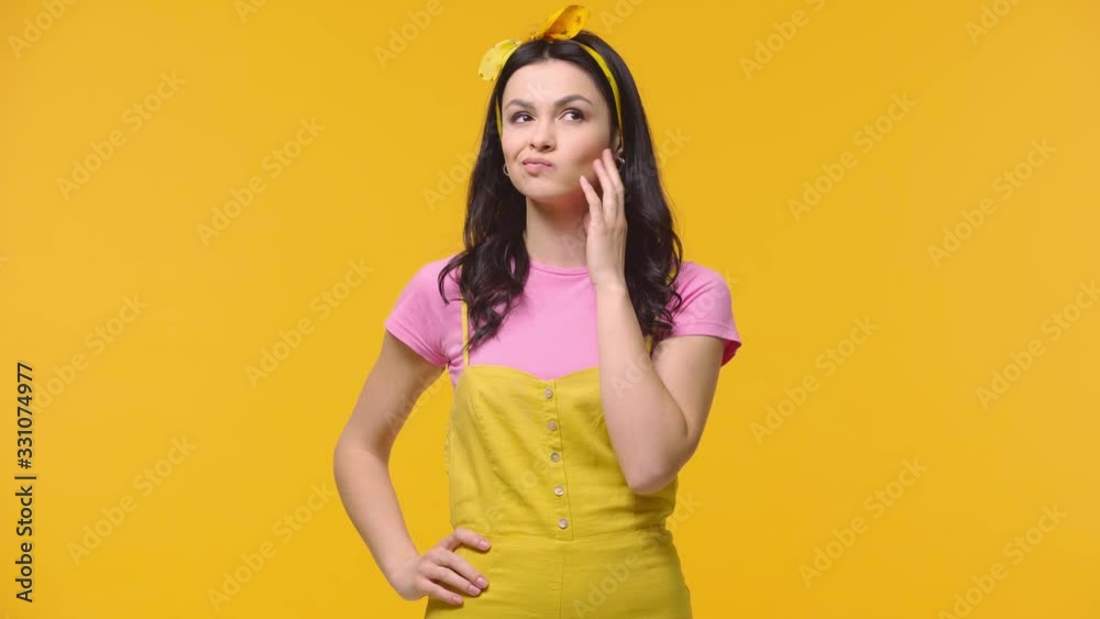 Thoughtful woman getting idea isolated on yellow Thoughtful woman getting idea isolated on yellow