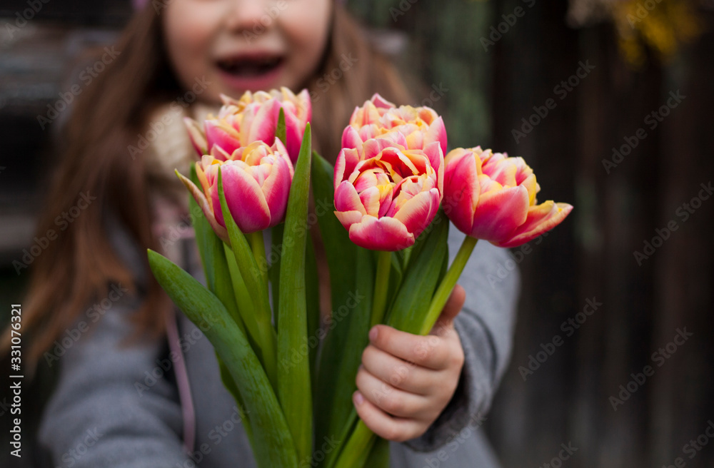 little girl with bouquet  of spring flowers tulips.march 8 ,mother's day concept