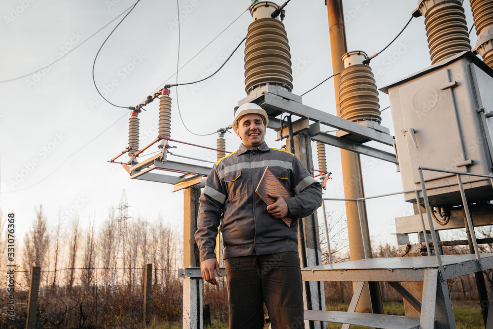 The energy engineer inspects the equipment of the substation. Power engineering. Industry