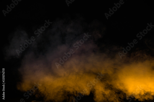 yellow smoke isolated on black background