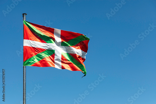 Close up shot of Basque Country waving flag on clear sky background