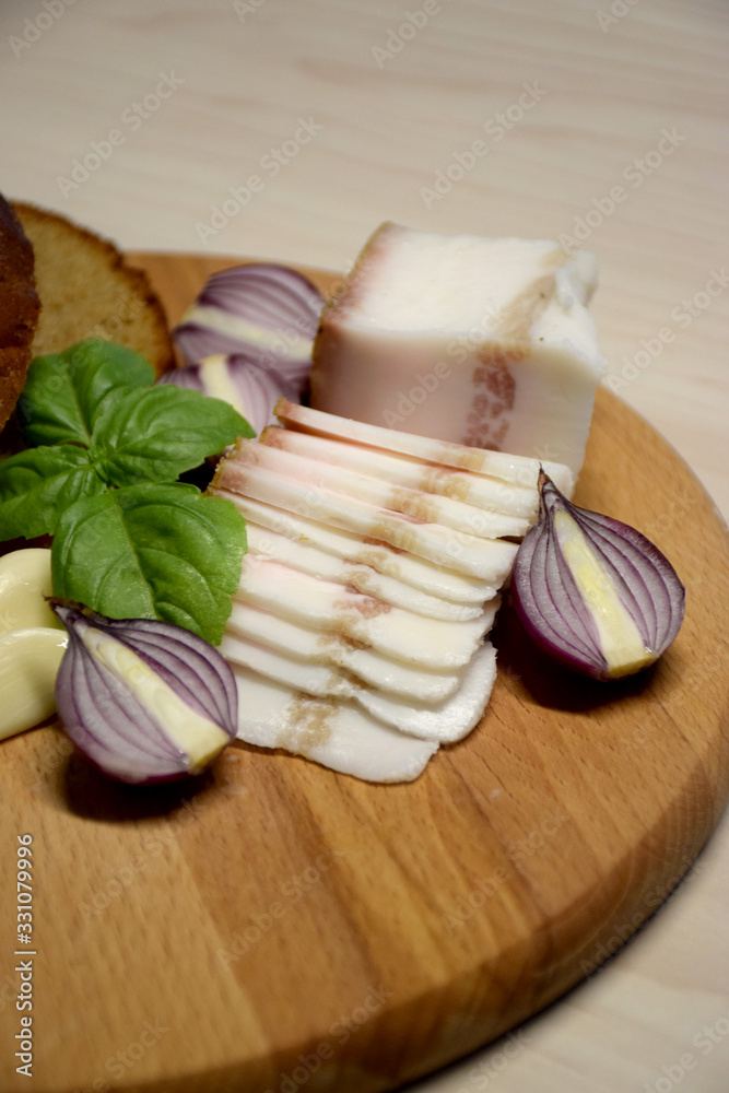 Bread and lard on a wooden cutting board