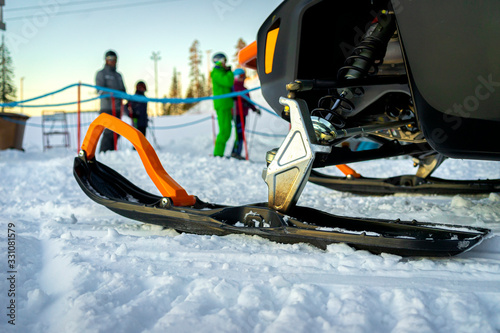 Close-up of a snowy runners of a snowmobile on the ski resort