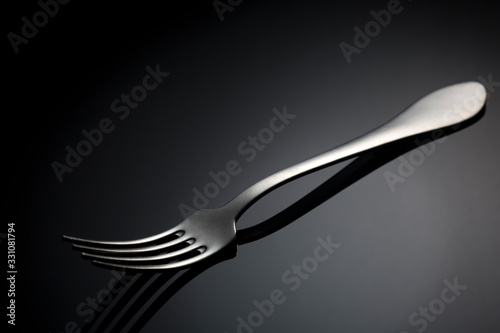 Fork with spot light on black background.