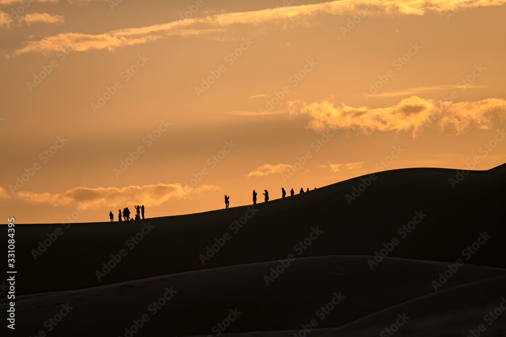Tourists on Dune at Sunrise, Sahara Desert, Morocco