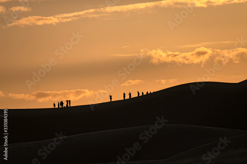 Tourists on Dune at Sunrise  Sahara Desert  Morocco