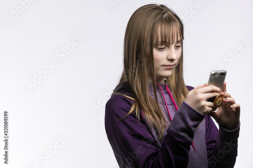 young girl texting on phone studio