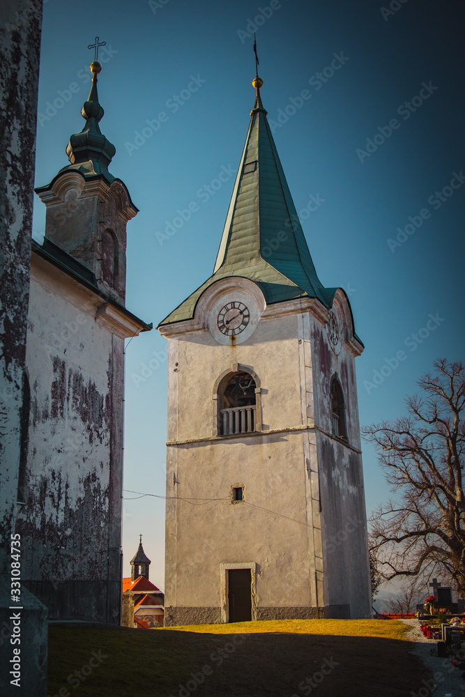 Fototapeta premium Bell tower of Zasavska sveta gora, on a sunny winter day. Beautiful religious chuch on the top of the hill in the centre of Slovenia, above Litija