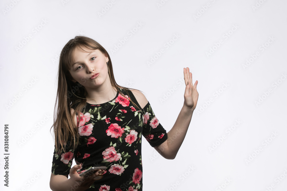 sassy pre-teen with phone in hand on studio background sassy pre-teen with phone in hand on studio background