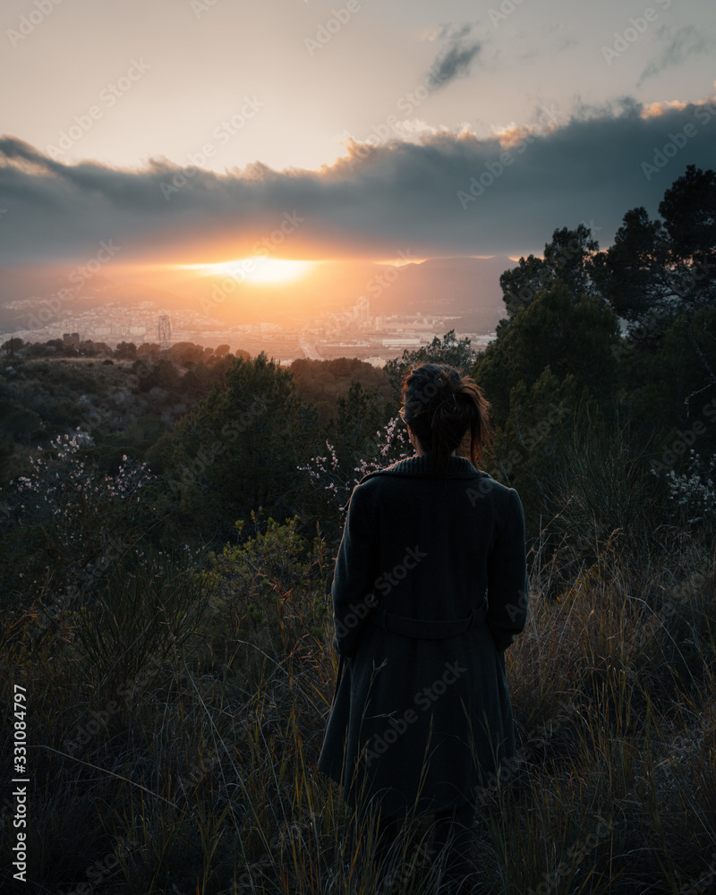 Rear view of woman looking at sunset over city Rear view of woman looking at sunset over city