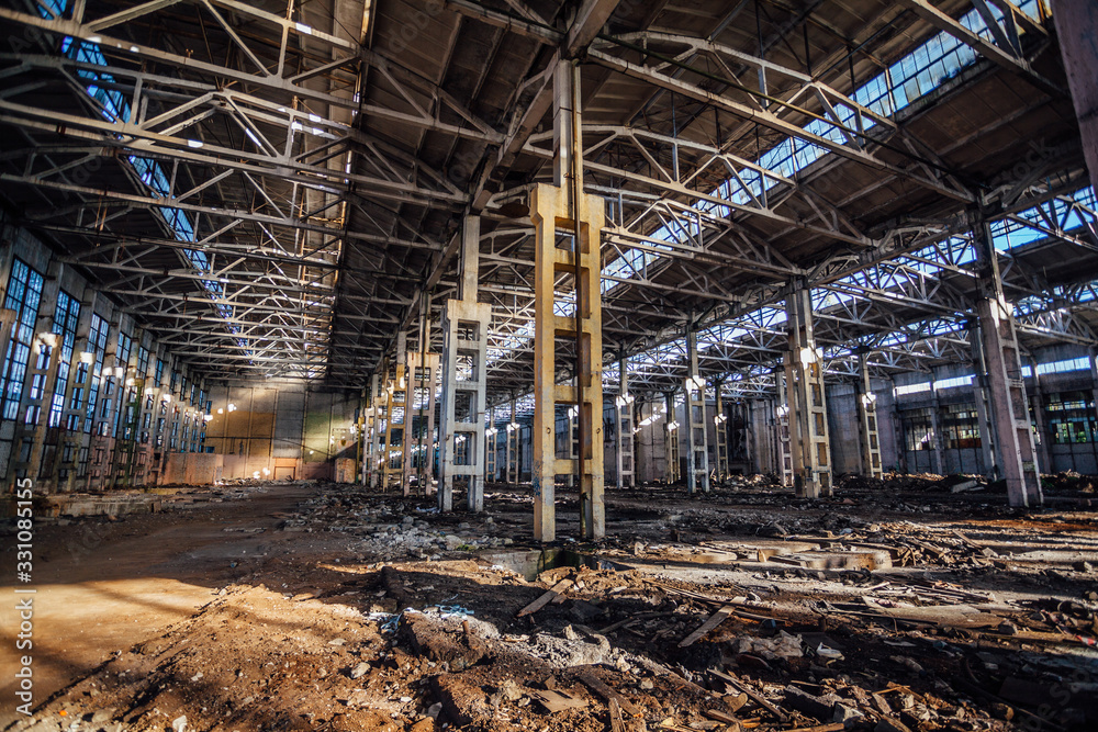 Abandoned large industrial hall with garbage waiting for demolition. Former Voronezh excavator manufacturing factory