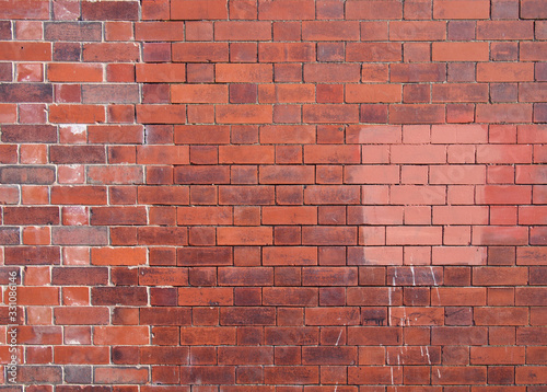 an old repaired patched exterior wall made of red bricks