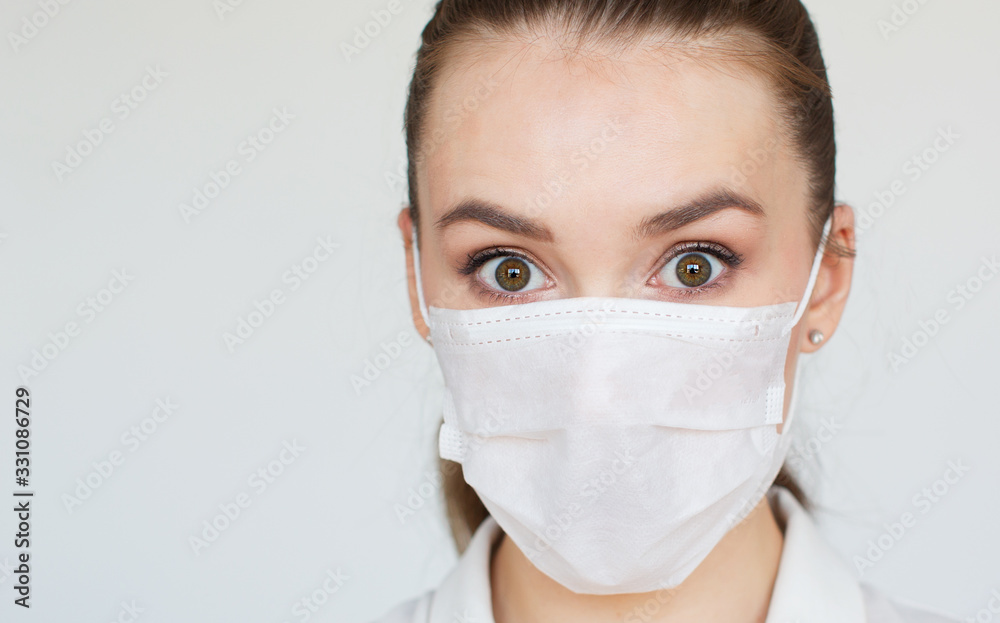 COVID-19 Pandemic Coronavirus Woman wearing face mask protective for spreading of disease virus SARS-CoV-2. Girl with surgical mask on face against Coronavirus Disease 2019, on white background COVID-19 Pandemic Coronavirus Woman wearing face mask protective for spreading of disease virus SARS-CoV-2. Girl with surgical mask on face against Coronavirus Disease 2019, on white background