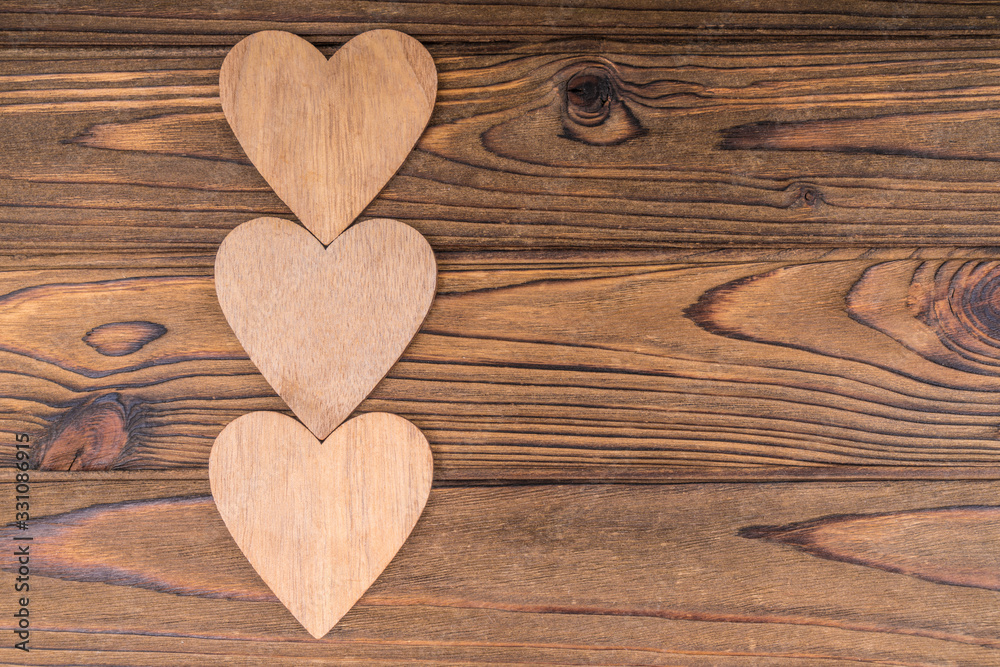 Three hearts, on a wooden background. romantic message, valentine's day. Copy space, lovers day Three hearts, on a wooden background. romantic message, valentine's day. Copy space, lovers day