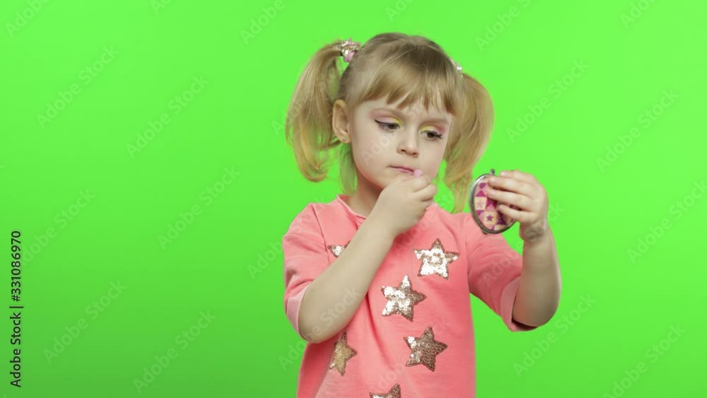 Caucasian girl on chroma key background applying red lipstick. Cosmetics, makeup Caucasian girl on chroma key background applying red lipstick. Cosmetics, makeup