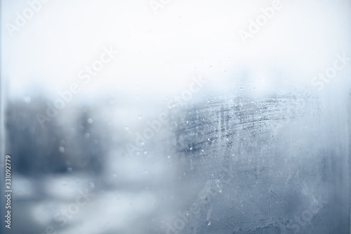 Texture. Foggy window with flowing water droplets. Can be used as a background.