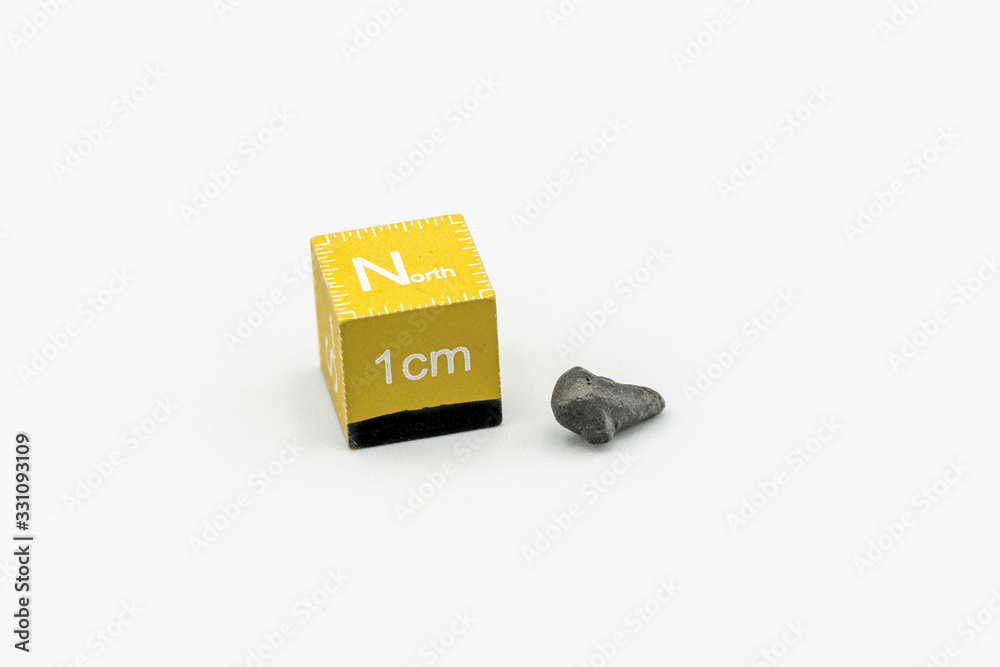 Black magnetic Atacaimite Tektite Meteorite isolated, a rock formed in a big meteorite collision at Atacama Desert. Amazing fusion textures over the surface because of the extreme temperatures reach
Black magnetic Atacaimite Tektite Meteorite isolated, a rock formed in a big meteorite collision at Atacama Desert. Amazing fusion textures over the surface because of the extreme temperatures reach