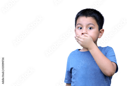Little boy holding hand over mouth. Child covering mouth with hand looking at camera.  Horizontal portrait on white background with copy space. © Janthana