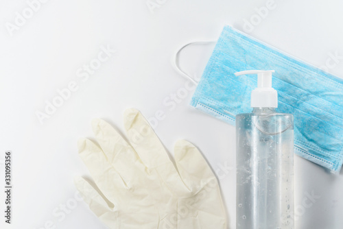Covid-19. Sanitizer gel, disposable hand gloves and medical mask at white medical table. Treatment and prevention of Chinese coronavirus in a hospital